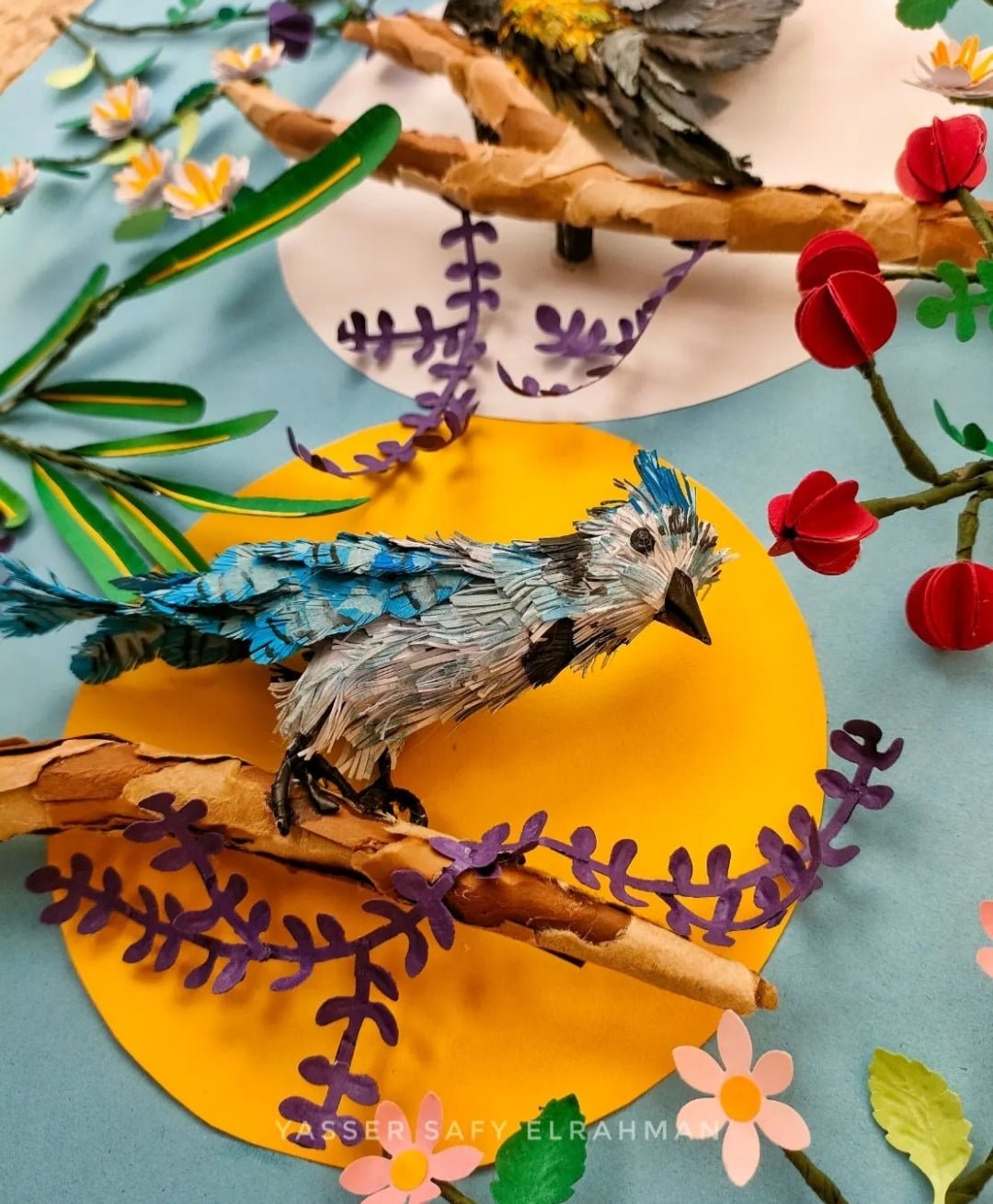 Colorful artwork by Yasser Safy Elrahman depicting various birds in a lush garden setting.