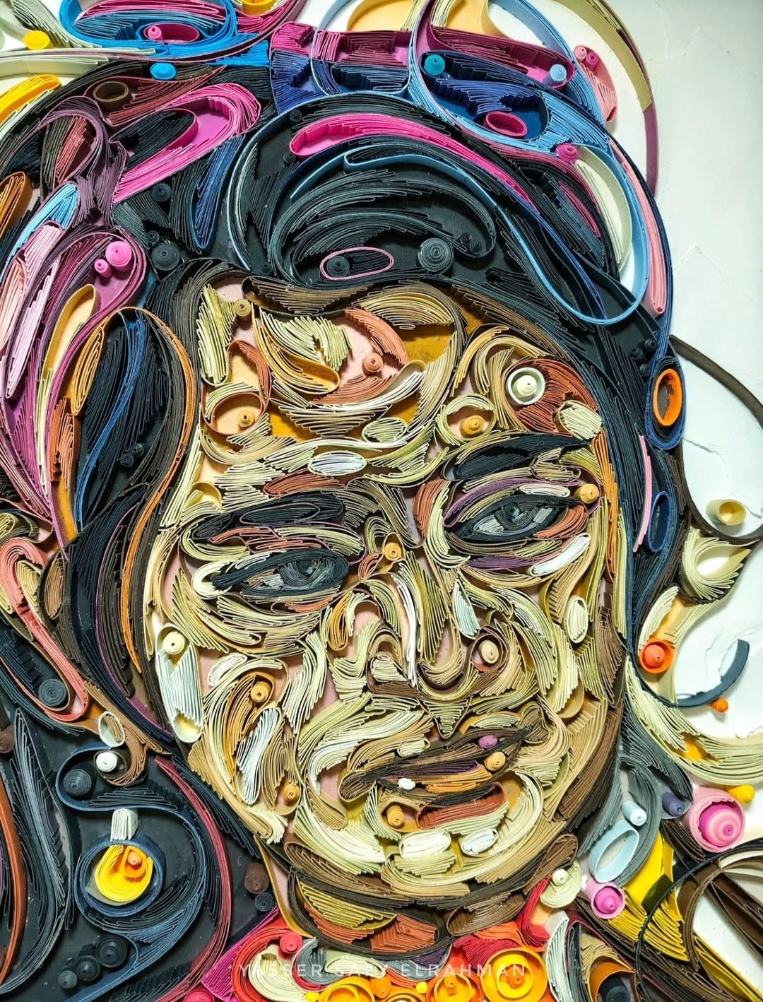 Custom paper quilling portrait artwork by Yasser Safy Elrahman, featuring intricate paper strips forming a personalized portrait.