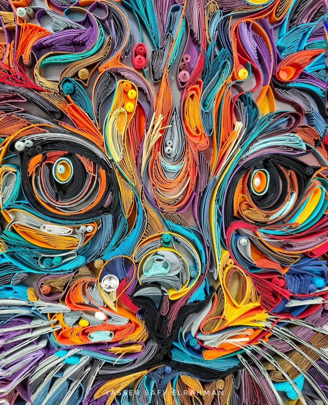 Colorful cat portrait artwork titled James in Colors by Yasser Safy Elrahman, featuring vibrant, abstract feline imagery.