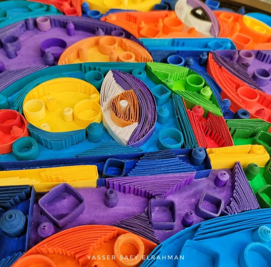 Abstract artwork titled Cubiest Faces by Yasser Safy Elrahman, featuring colorful geometric face designs.