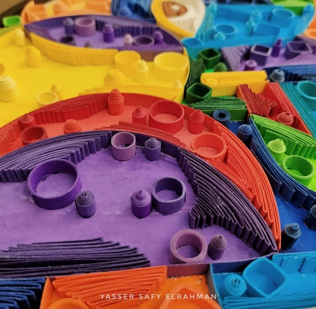 Abstract artwork titled "Cubiest Faces" by Yasser Safy Elrahman featuring colorful geometric face designs.