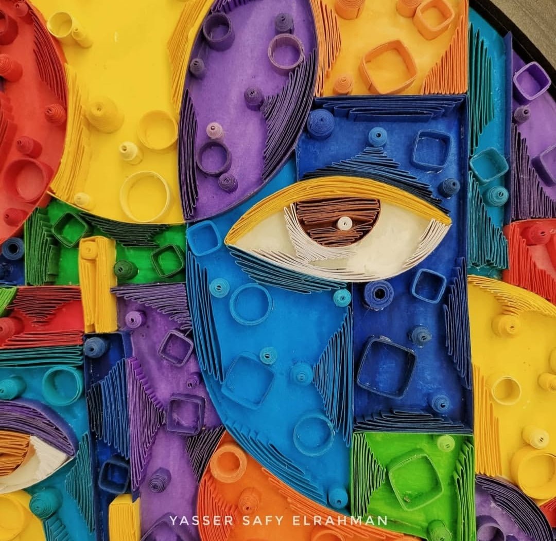 Abstract artwork titled Cubiest Faces by Yasser Safy Elrahman, featuring vibrant geometric face designs.