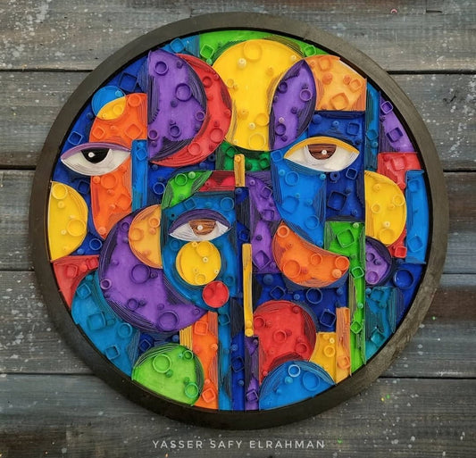 Abstract artwork titled Cubiest Faces by Yasser Safy Elrahman, featuring colorful geometric face designs.