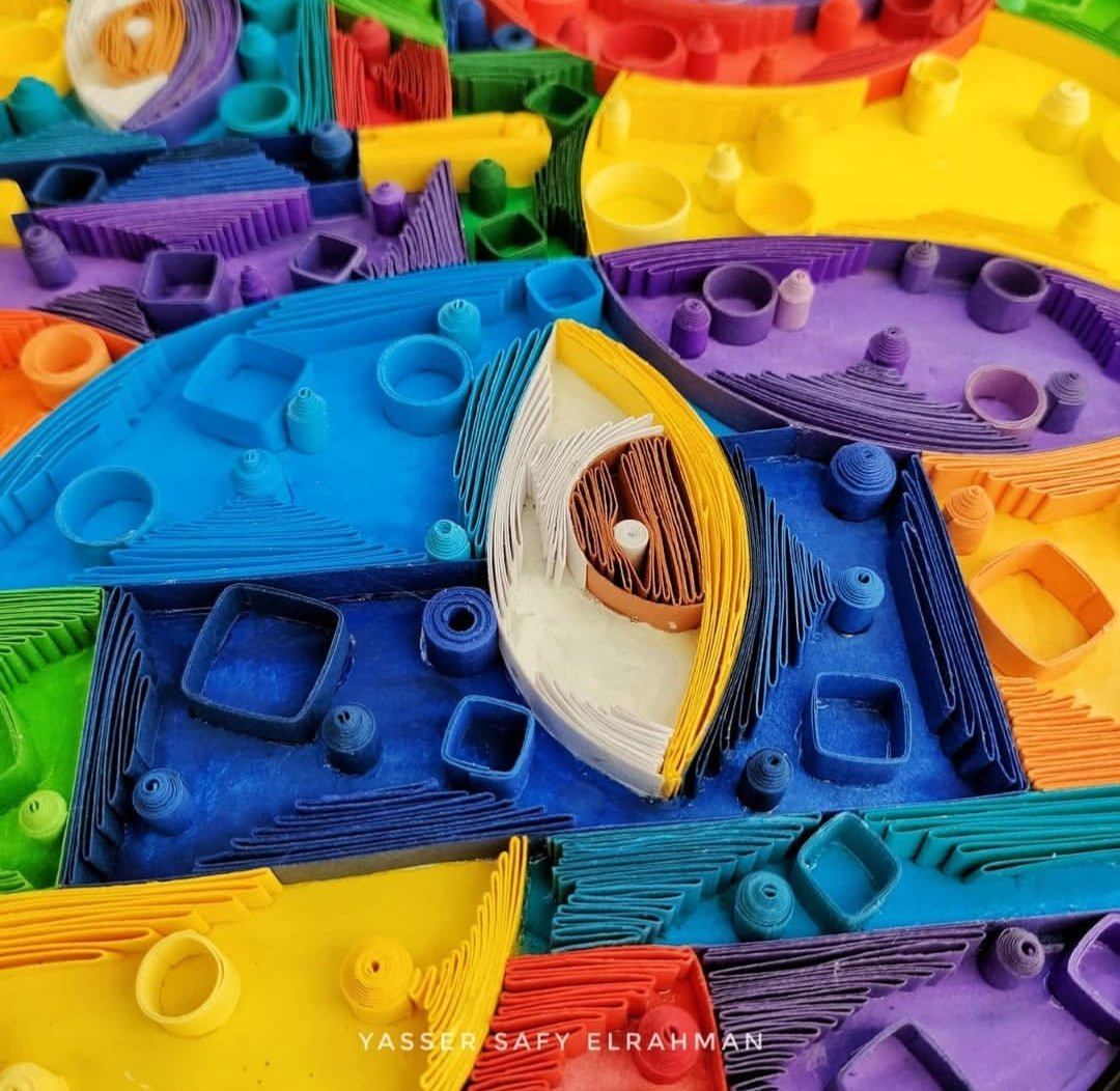 Abstract artwork titled Cubiest Faces by Yasser Safy Elrahman, featuring colorful geometric face designs in a modern art style.