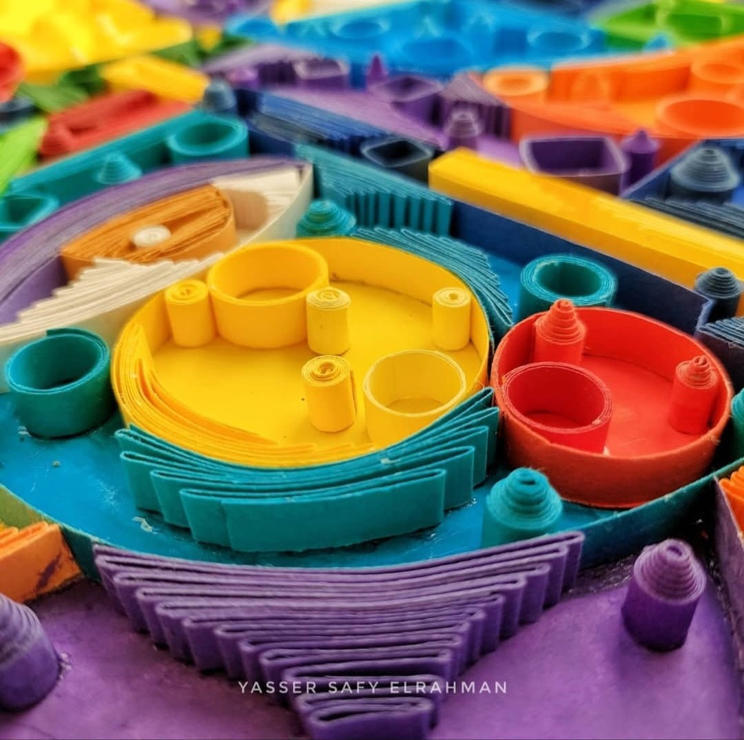 Abstract artwork titled Cubiest Faces by Yasser Safy Elrahman featuring colorful geometric face designs.