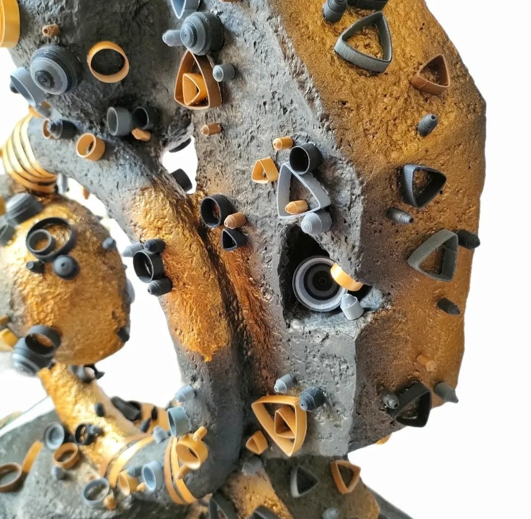 Yasser Safy Elrahman darkening of the light sculpture featuring abstract dark and light metal forms on a pedestal.