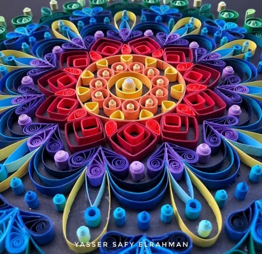 Colorful mandala artwork titled "Kaleidoscope of Peace" by Yasser Safy Elrahman featuring vibrant, intricate geometric patterns.