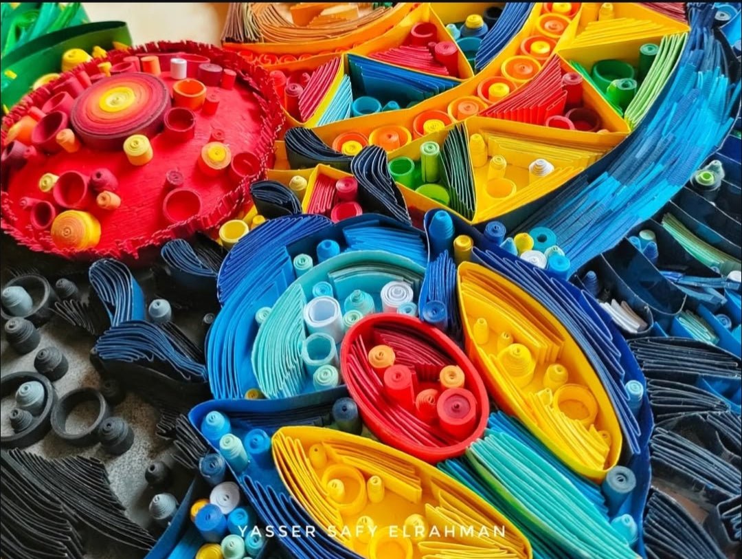 Ancient Egyptian paper quilling artwork titled "Nah Nitry (Sacred Life)" by Yasser Safy Elrahman, featuring intricate designs and vibrant colors.