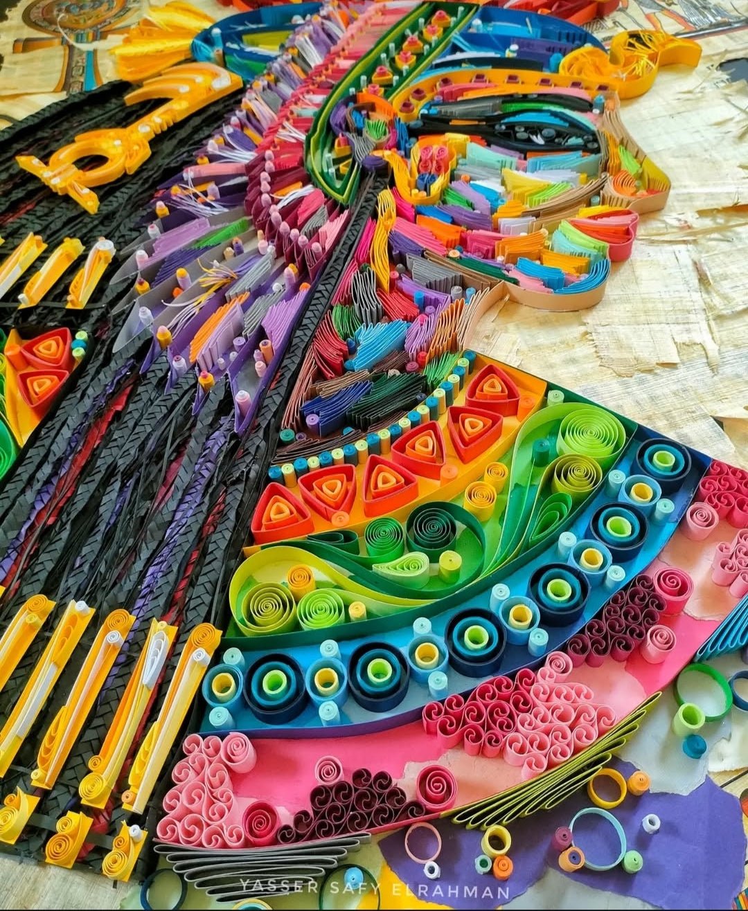 Colorful artwork titled "Nefertari: She is the One for Whom the Sun Shines" by Yasser Safy Elrahman, featuring vibrant Egyptian-inspired designs.