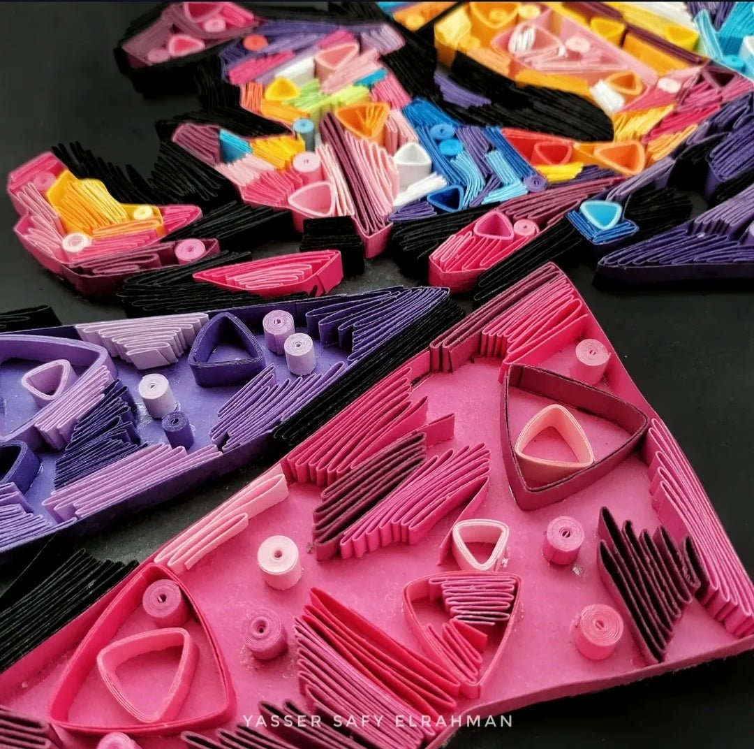 Colorful paper quilling artwork featuring The Joker, titled "Chaos in Colors" by Yasser Safy Elrahman.