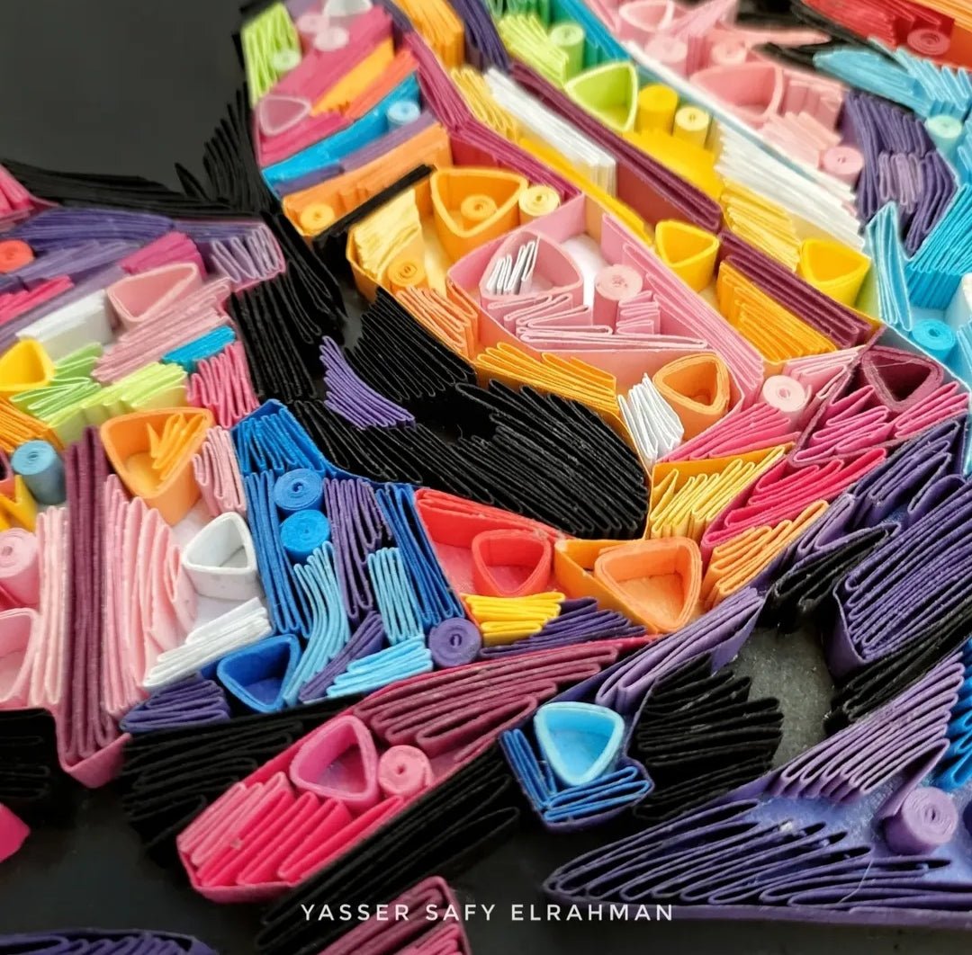 Colorful paper quilling artwork of The Joker titled Chaos in Colors by Yasser Safy Elrahman, showcasing detailed paper art.