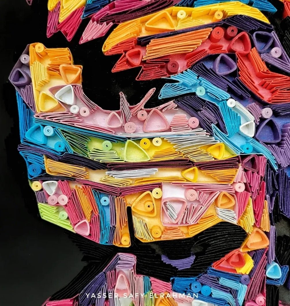 Colorful paper quilling artwork of The Joker from "Chaos in Colors" by Yasser Safy Elrahman featuring vibrant, intricate paper art design.