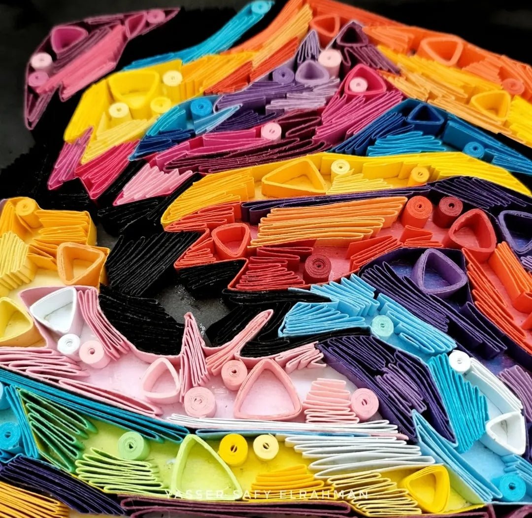 Colorful paper quilling artwork of The Joker titled Chaos in Colors by Yasser Safy Elrahman, featuring intricate paper art details.